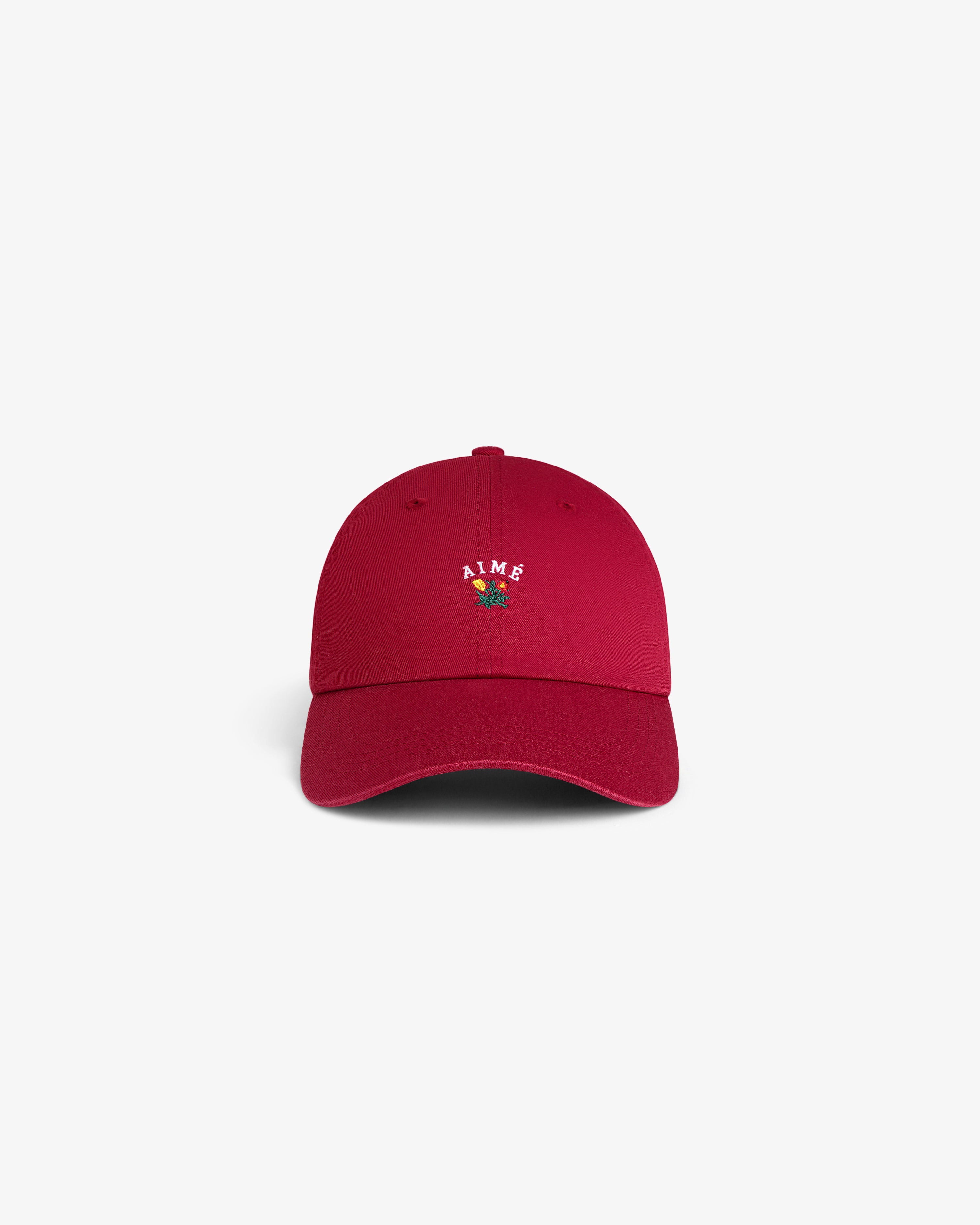 Crest Logo Hat in red with AIME and small flower embroidery on front, shown against a white background.