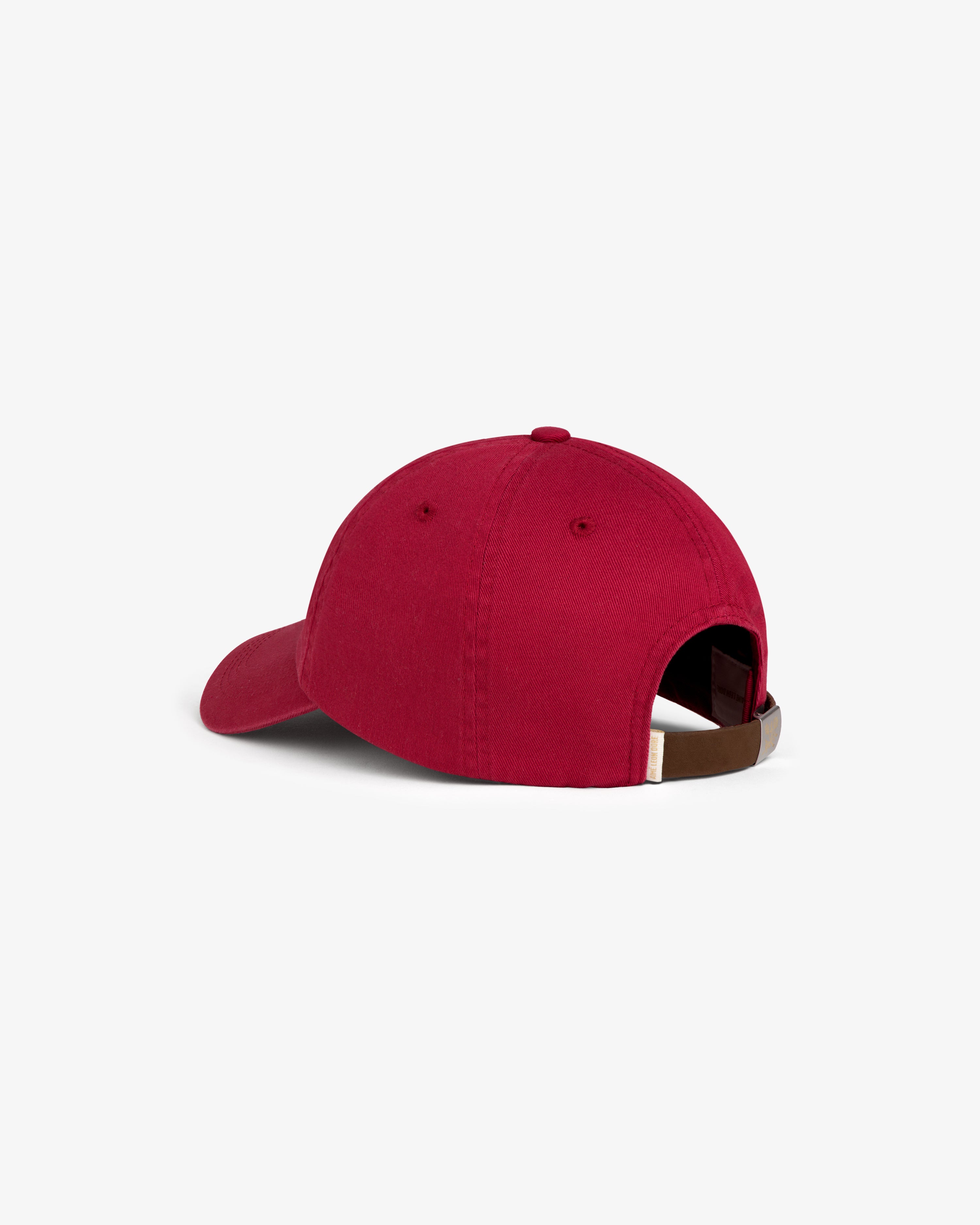 Crest Logo Hat in red, shown from the back with adjustable strap and metal clasp.