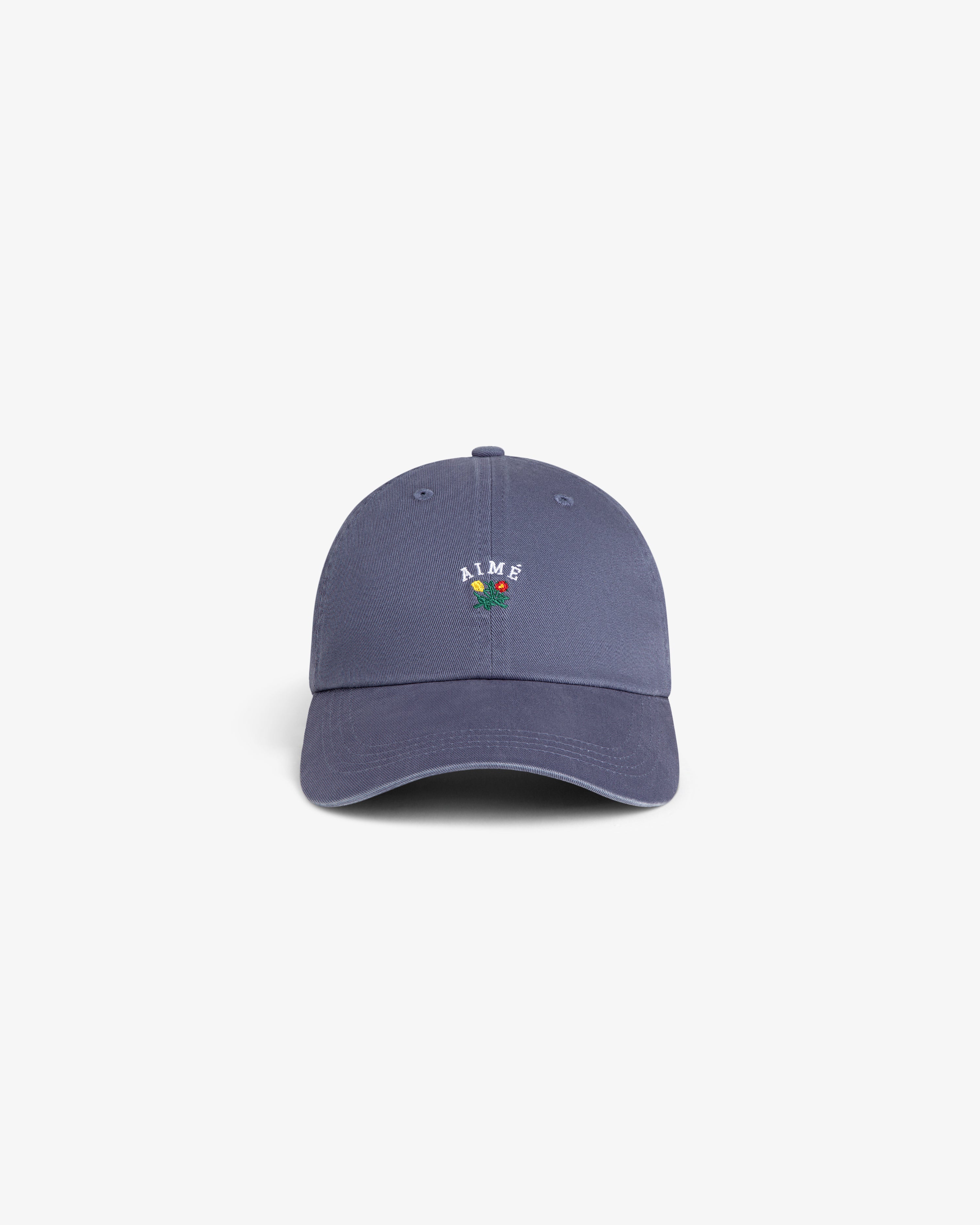 Crest Logo Hat in blue with AIME and a small flower embroidered on front, displayed on a white background.