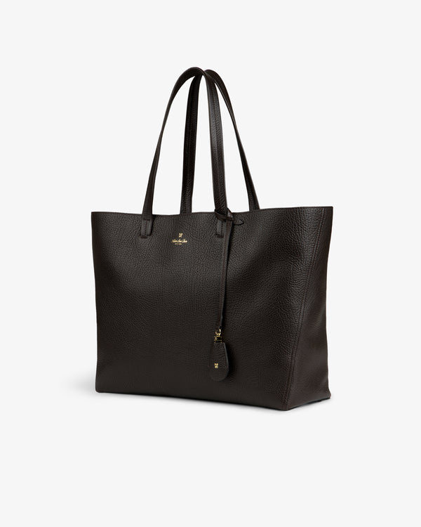 Tumbled Leather Tote Bag in dark brown with double handles, gold logo, and keychain on white background.