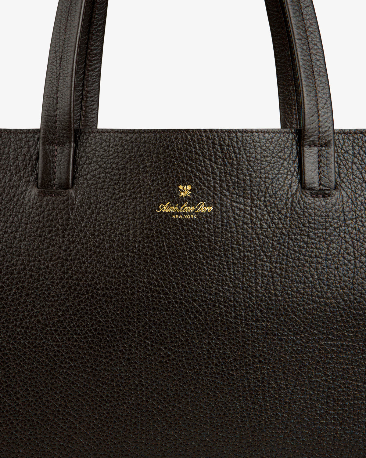 Close-up of a Tumbled Leather Tote Bag in dark brown with gold Adam Lee Bros. New York logo under the handle.