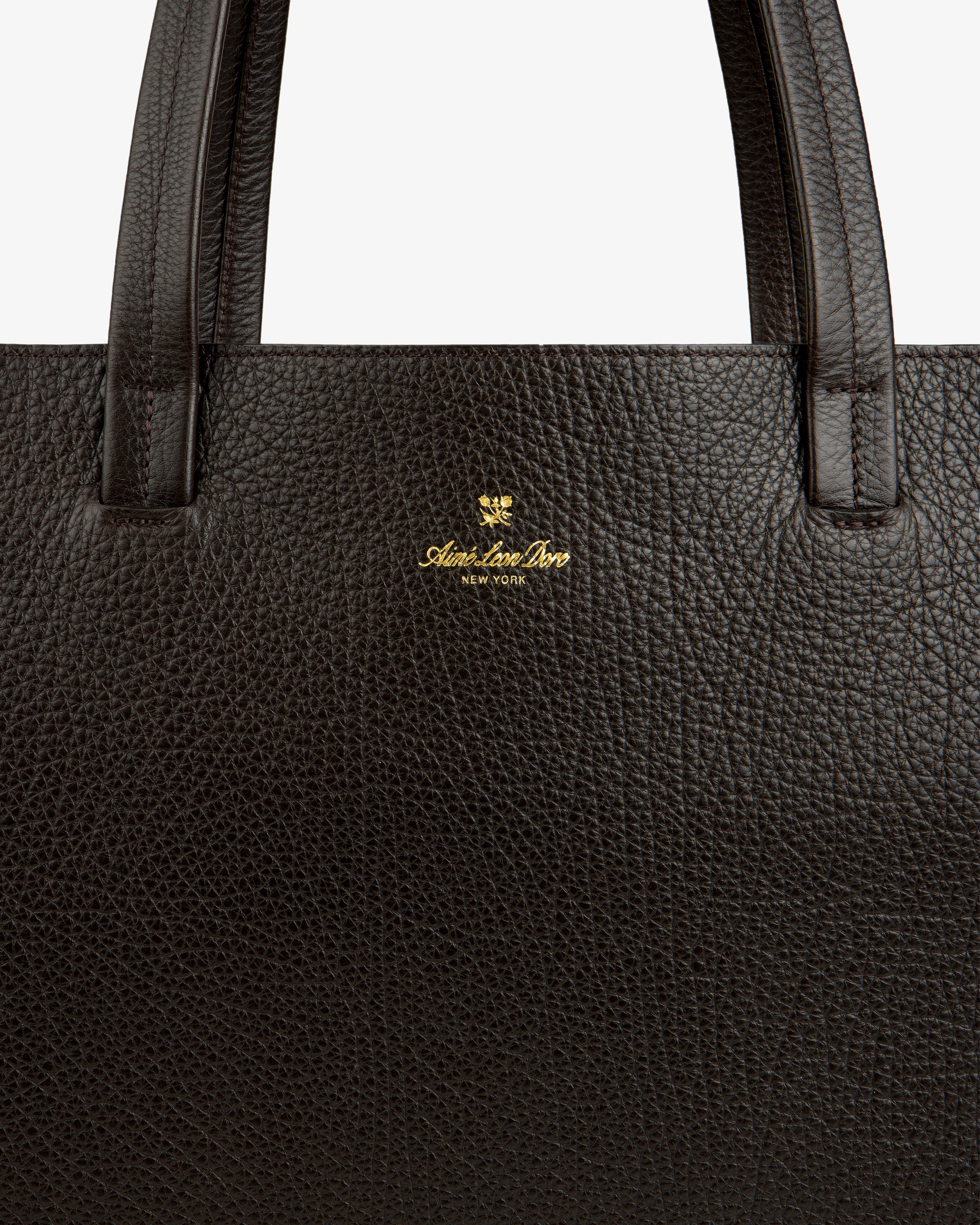 Close-up of a Tumbled Leather Tote Bag in dark brown with gold Adam Lee Bros. New York logo under the handle.