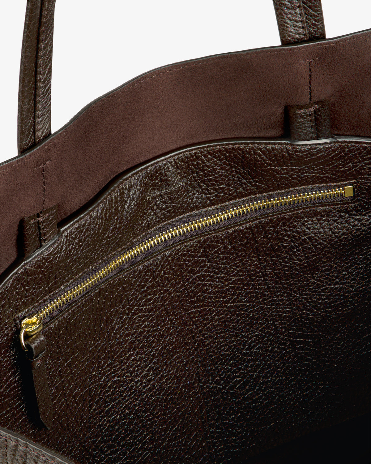 Close-up of the Tumbled Leather Tote Bag, featuring a gold zipper pocket and textured brown leather detailing inside.