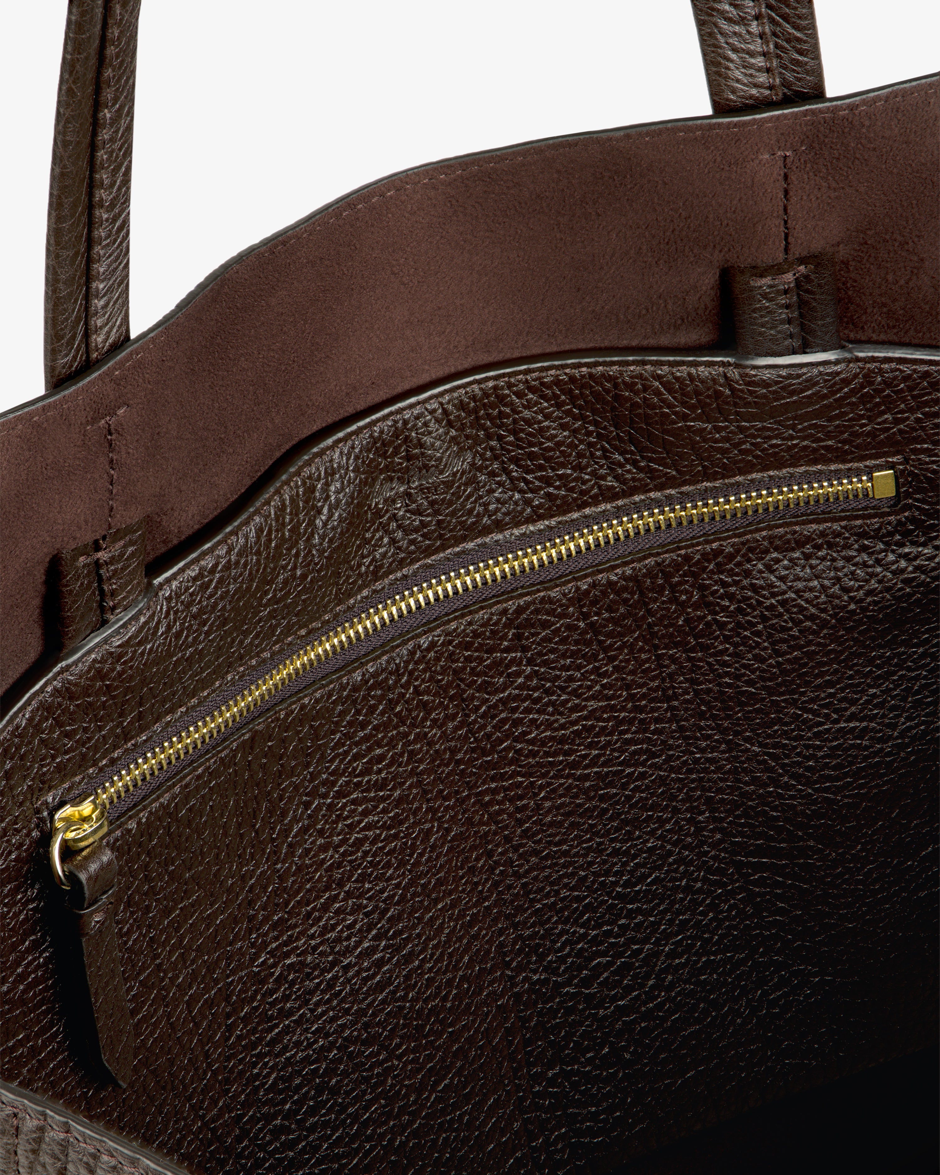 Close-up of the Tumbled Leather Tote Bag, featuring a gold zipper pocket and textured brown leather detailing inside.