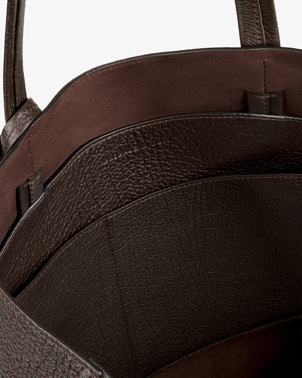 Close-up of the Tumbled Leather Tote Bag, featuring textured brown leather and visible inner compartments.