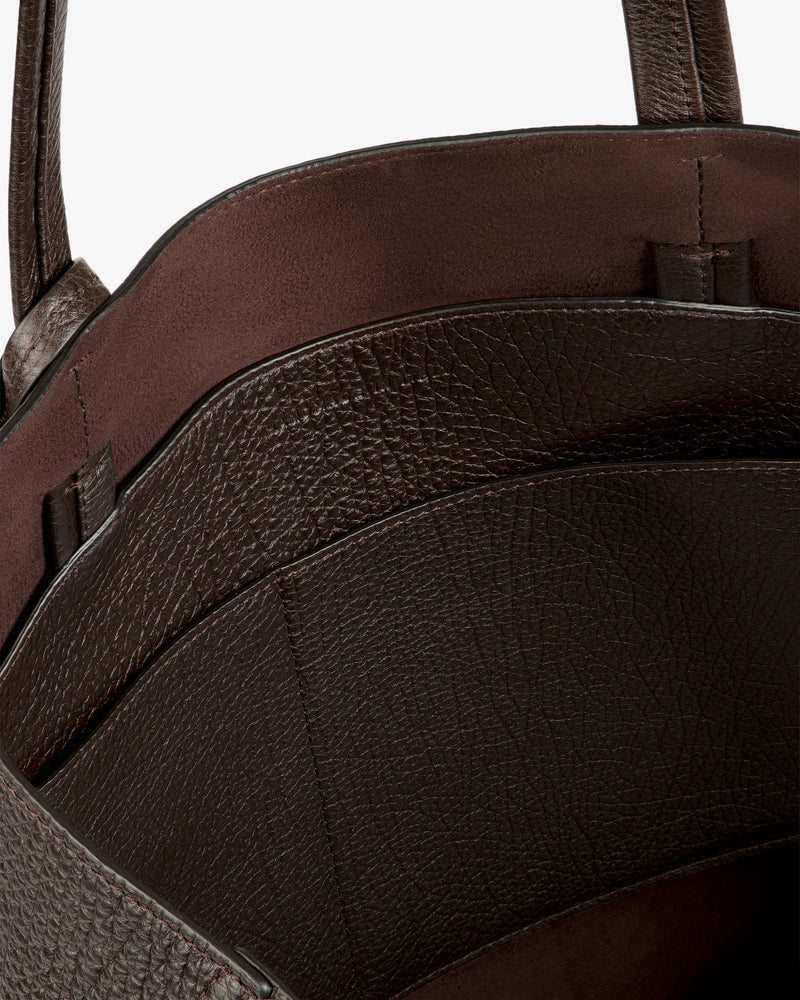 Close-up of the Tumbled Leather Tote Bag, featuring textured brown leather and visible inner compartments.