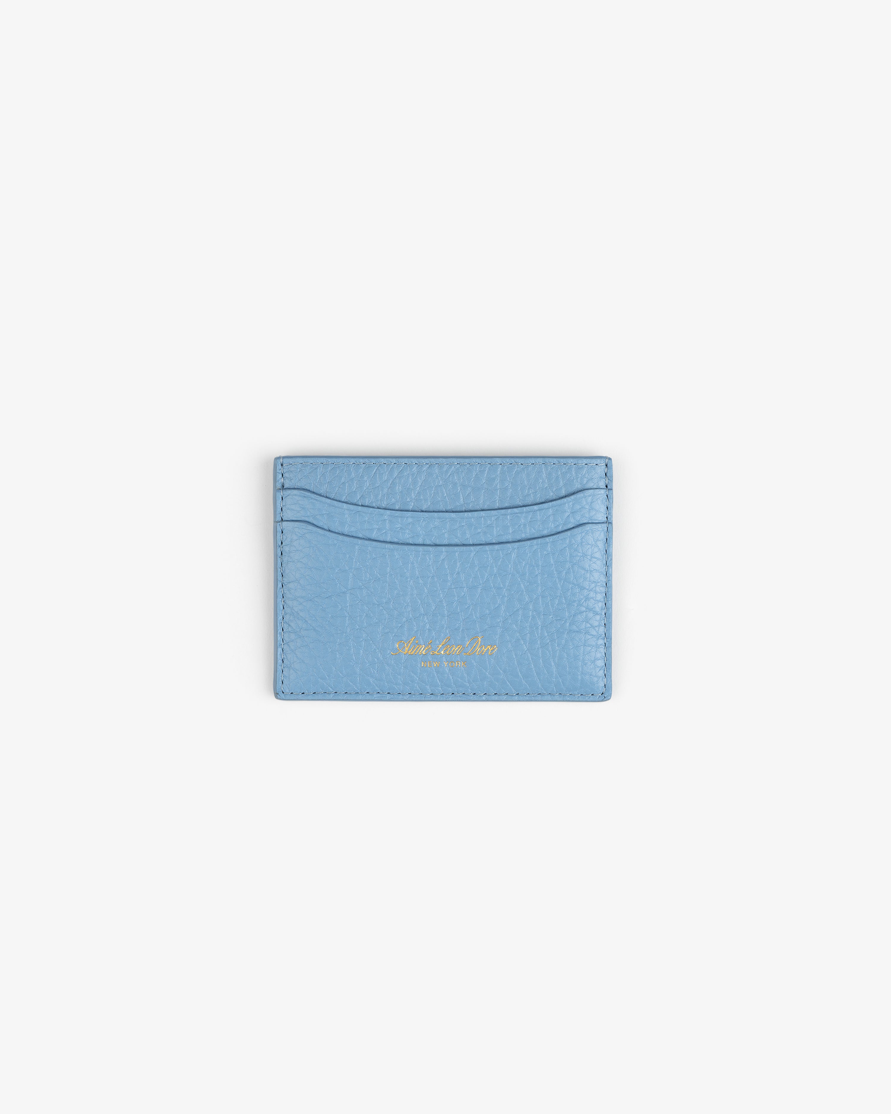 Tumbled Leather Card Holder in light blue with two slots and gold text, shown on a white background.