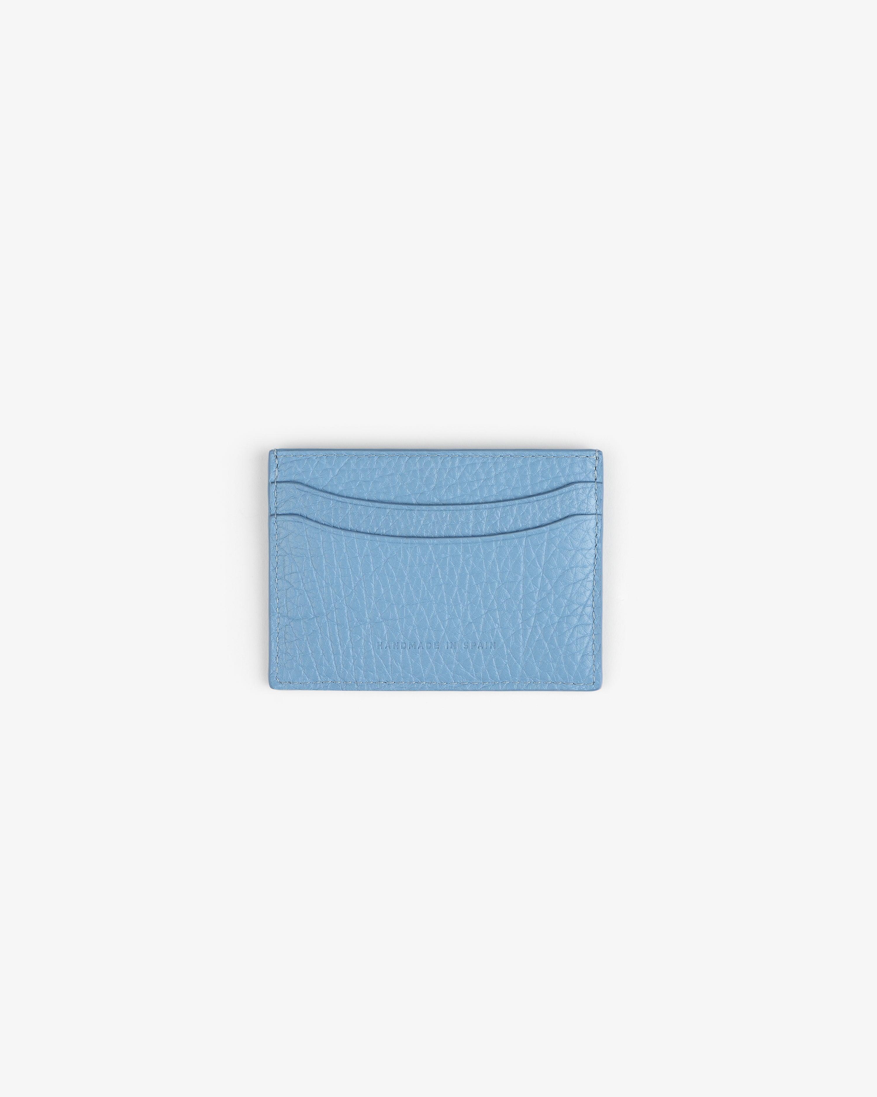 Tumbled Leather Card Holder in light blue leather with two slots, displayed on a plain white background.