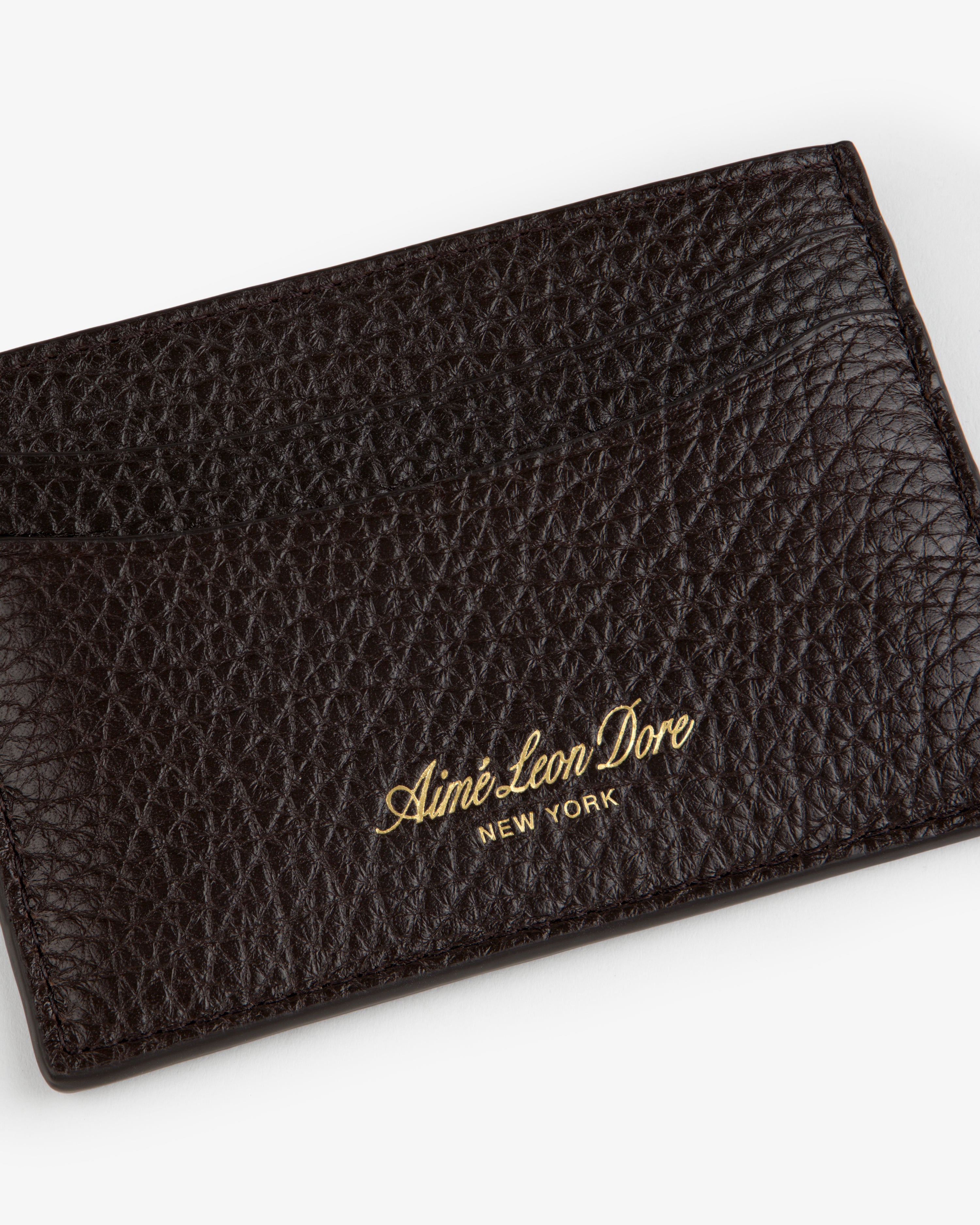 Tumbled Leather Card Holder in dark brown, gold Aimé Leon Dore NEW YORK embossing on textured leather front.
