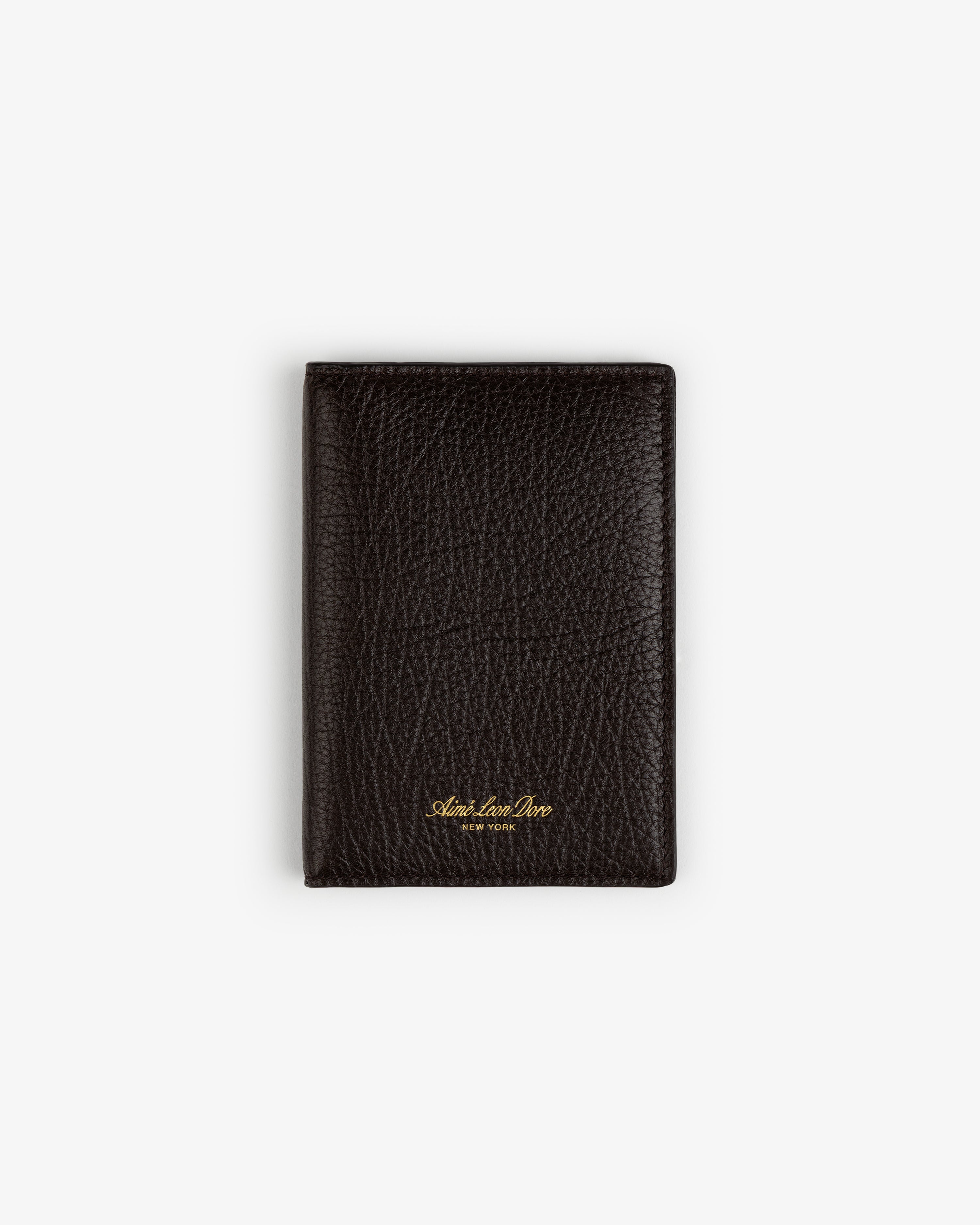 A black Tumbled Leather Passport Holder with gold lettering, shown closed on a plain white background.