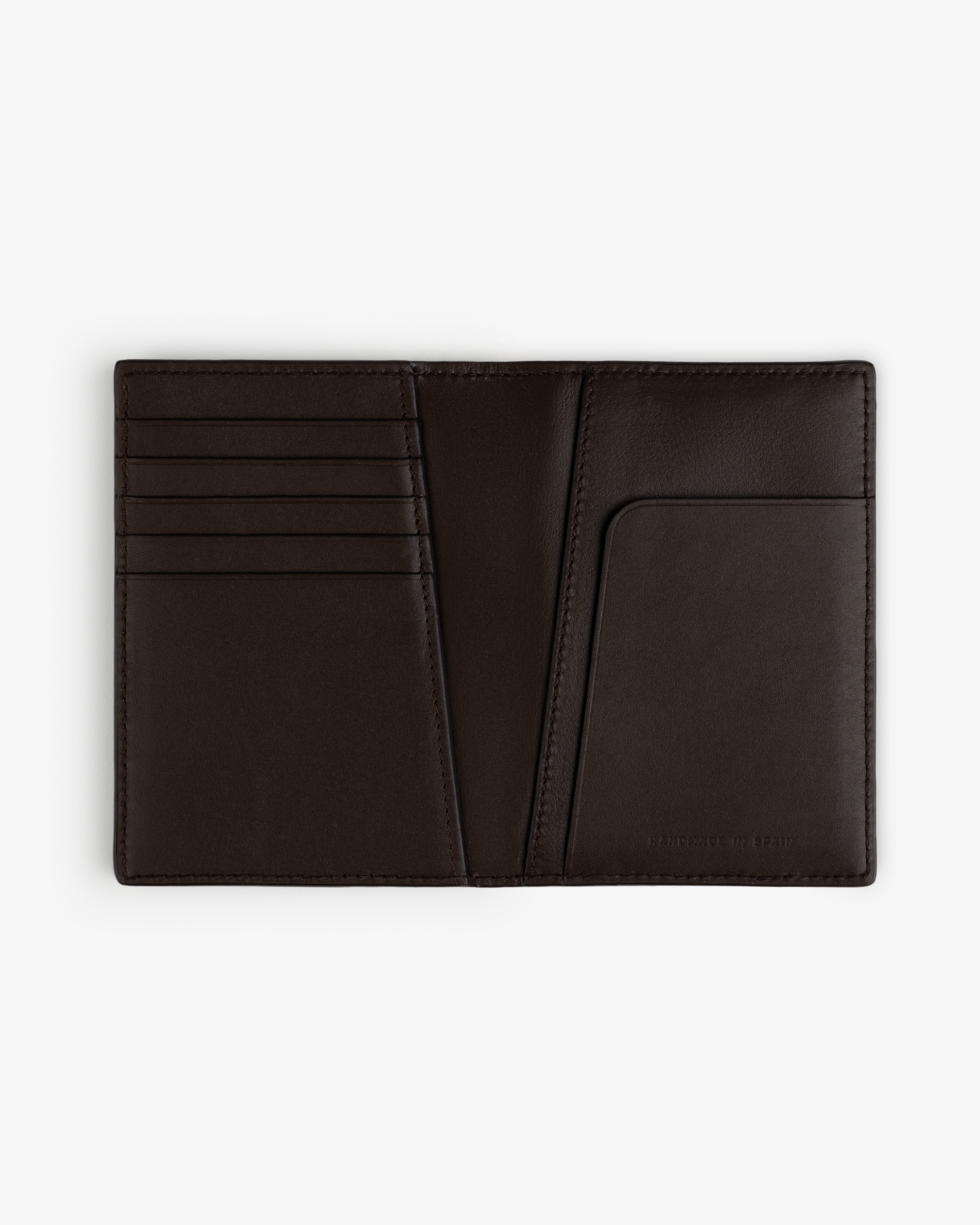 Tumbled Leather Passport Holder in black, open to show card slots and pocket, displayed flat on a white background.