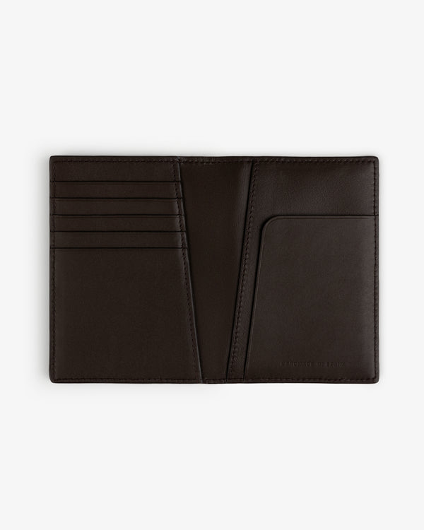 Tumbled Leather Passport Holder in black, open to show card slots and pocket, displayed flat on a white background.
