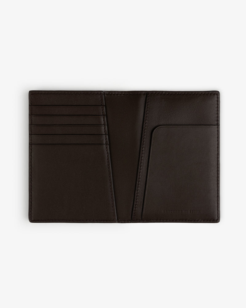Tumbled Leather Passport Holder in black, open to show card slots and pocket, displayed flat on a white background.
