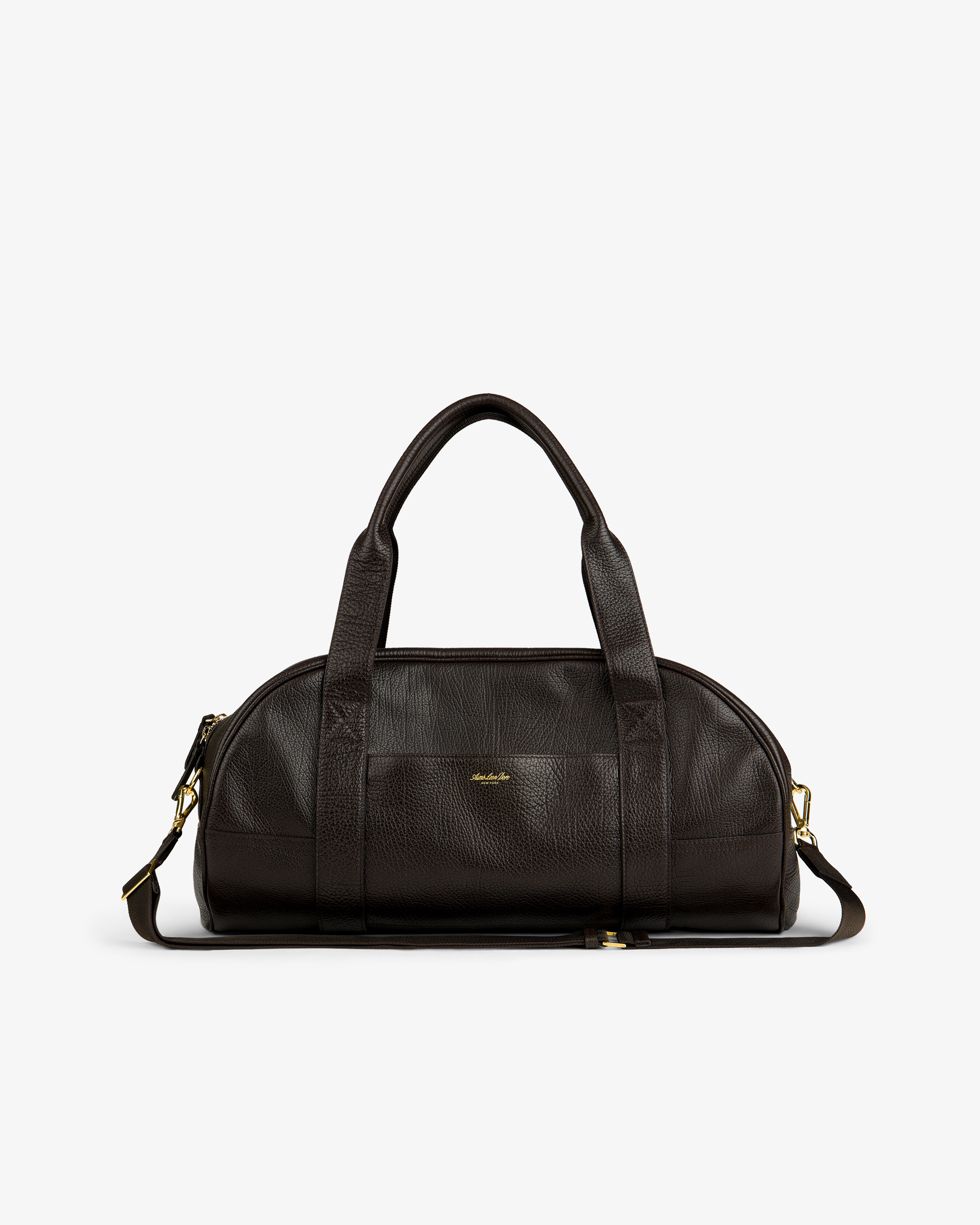 Tumbled Leather Duffle in dark brown with handles, shoulder strap, and gold hardware on a white background.