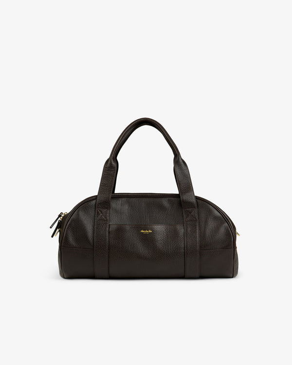 Tumbled Leather Duffle in dark brown with two handles, gold zipper, and a small gold logo on the front.