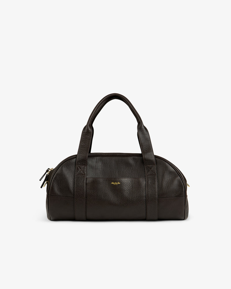 Tumbled Leather Duffle in dark brown with two handles, gold zipper, and a small gold logo on the front.