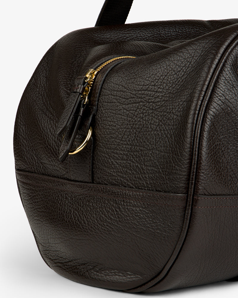 Close-up of the Tumbled Leather Duffle in textured dark brown leather with zip and gold hardware.