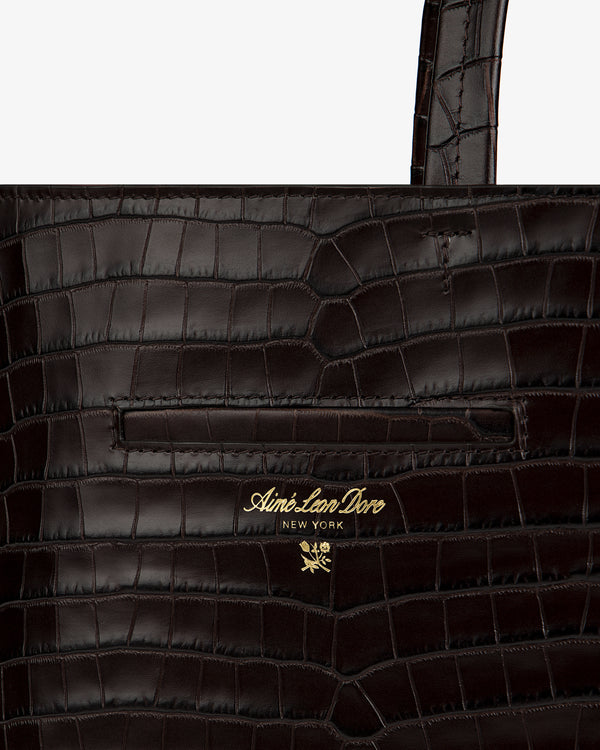 Dark brown croc-embossed leather Croc-Embossed Leather Shoulder Bag with gold logo text and a small flower emblem.