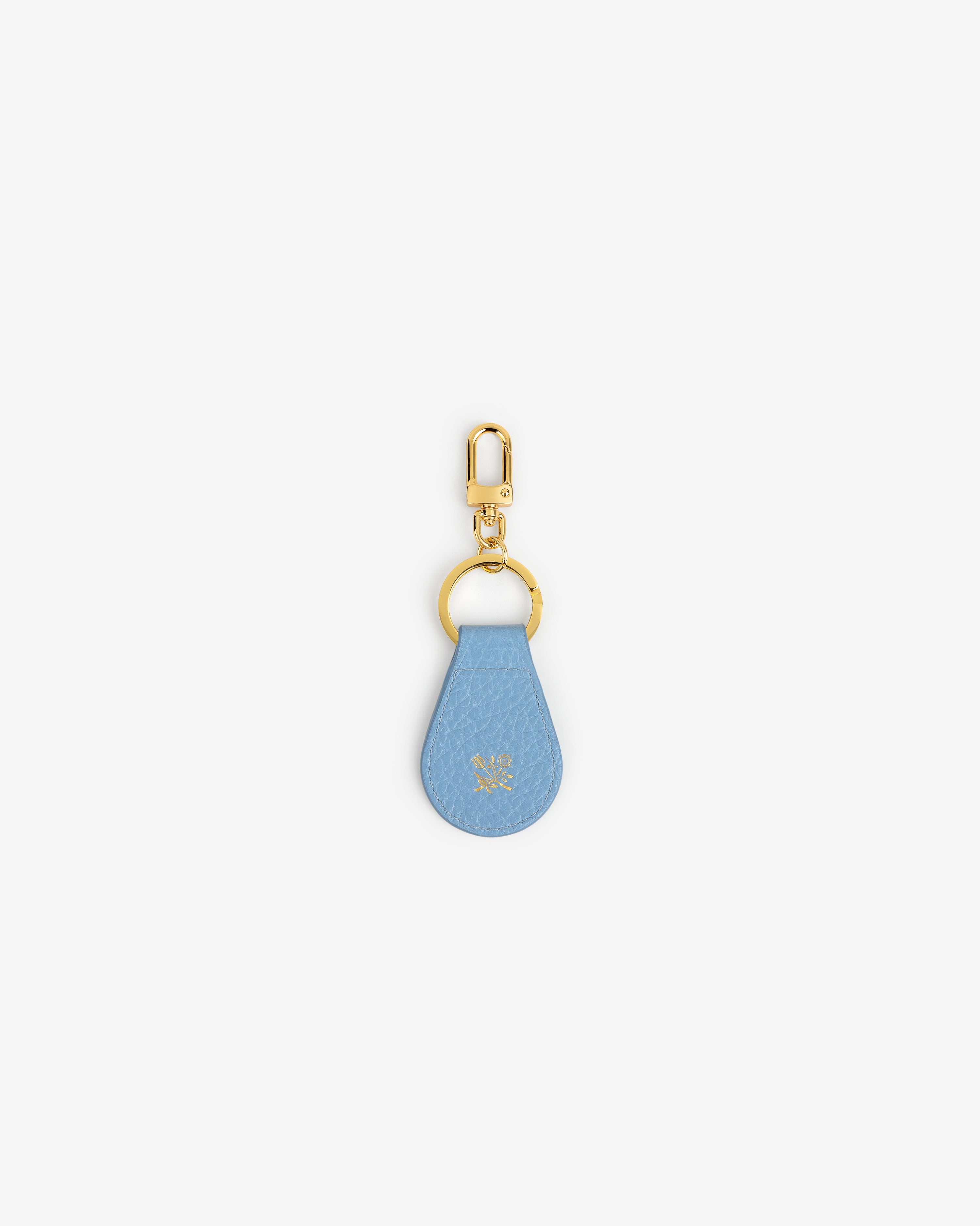 Tumbled Leather Key Fob: blue leather teardrop, gold hardware, small embossed logo near center.