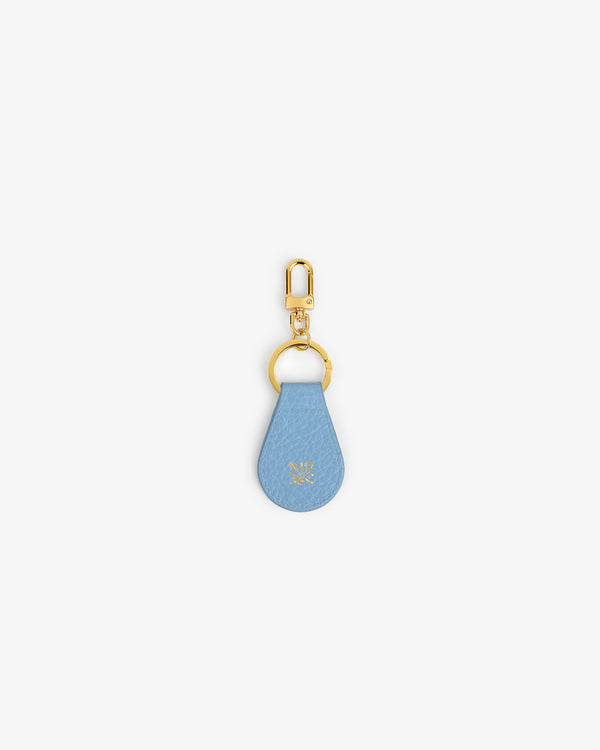 Tumbled Leather Key Fob: blue leather teardrop, gold hardware, small embossed logo near center.
