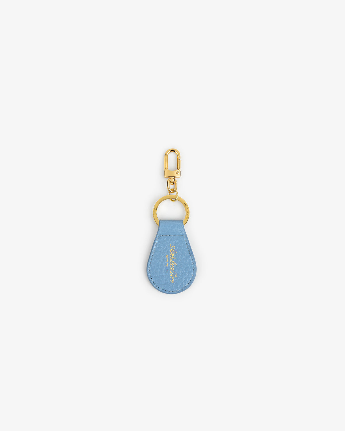 Tumbled Leather Key Fob: light blue teardrop design with gold hardware, shown on a white background.