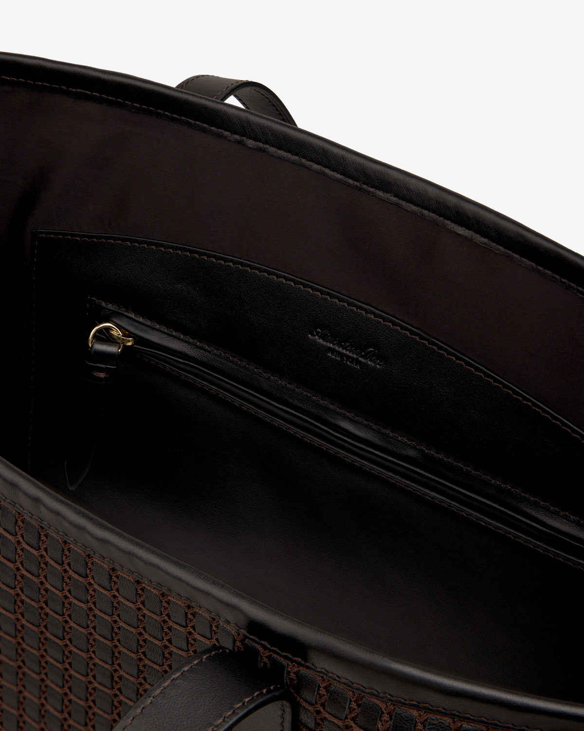 Interior view of a dark brown Woven Leather Tote Bag featuring a zippered pocket.