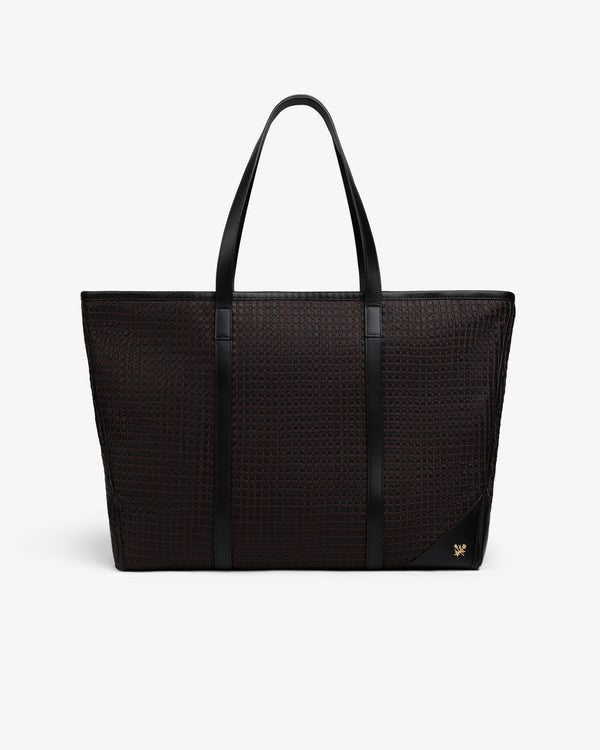 Black Woven Leather Tote Bag with a woven grid pattern, slim shoulder straps, and a gold emblem in the bottom corner.