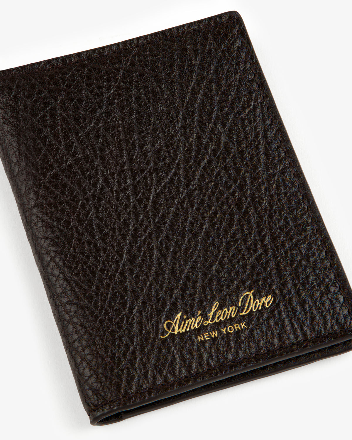 Tumbled Leather Bi-Fold Wallet in black with gold Aimé Leon Dore NEW YORK embossing on the textured front.