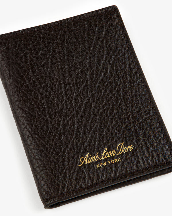 Tumbled Leather Bi-Fold Wallet in black with gold Aimé Leon Dore NEW YORK embossing on the textured front.