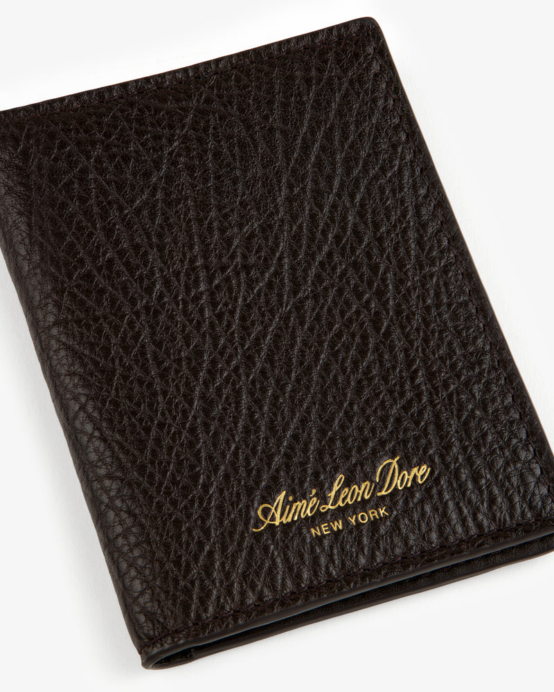 Tumbled Leather Bi-Fold Wallet in black with gold Aimé Leon Dore NEW YORK embossing on the textured front.