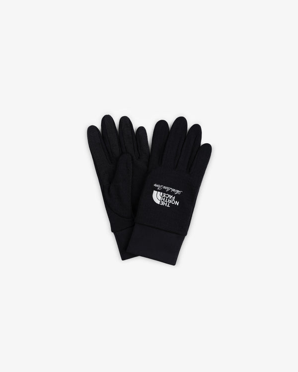 ALD/The North Face DOTKNIT™ Liner Gloves in black with white logo, laid flat on a white background.