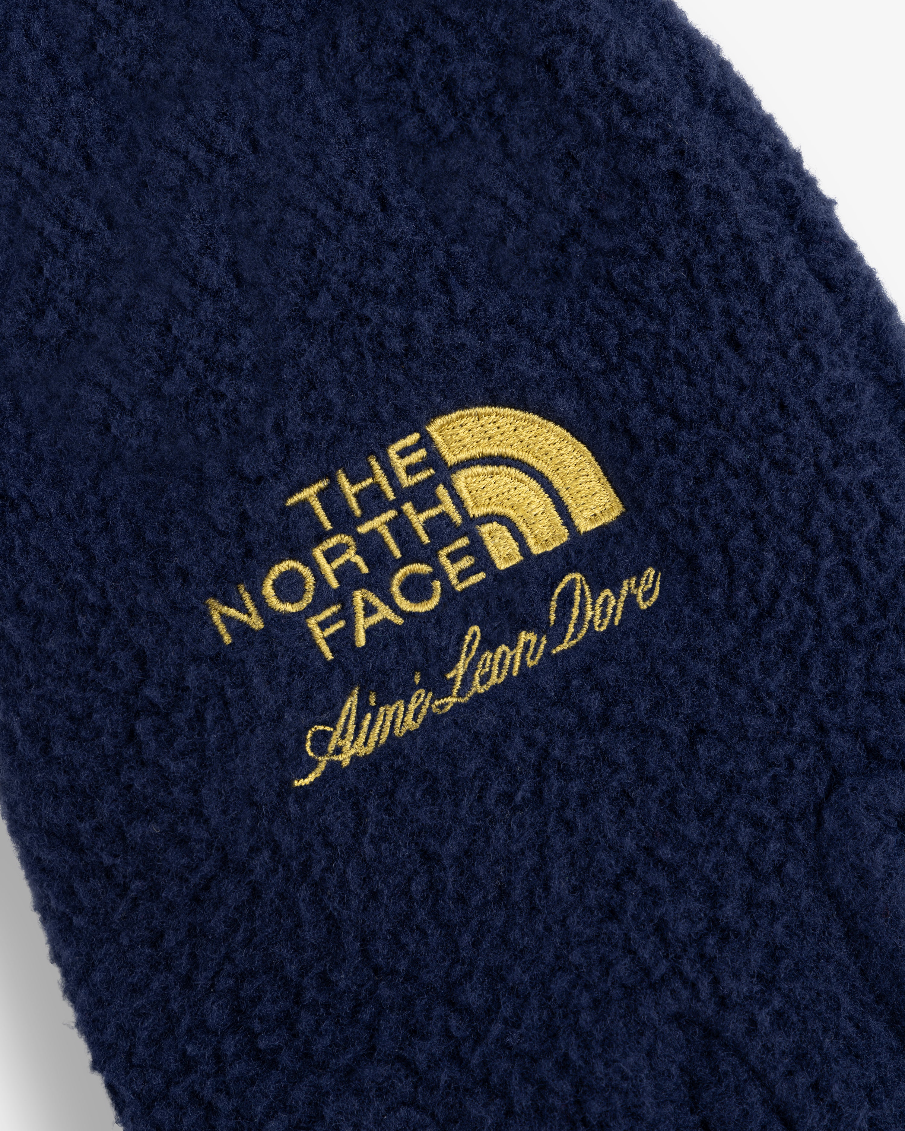 Navy ALD / The North Face Fleece Gloves with gold embroidered logos shown in close-up.