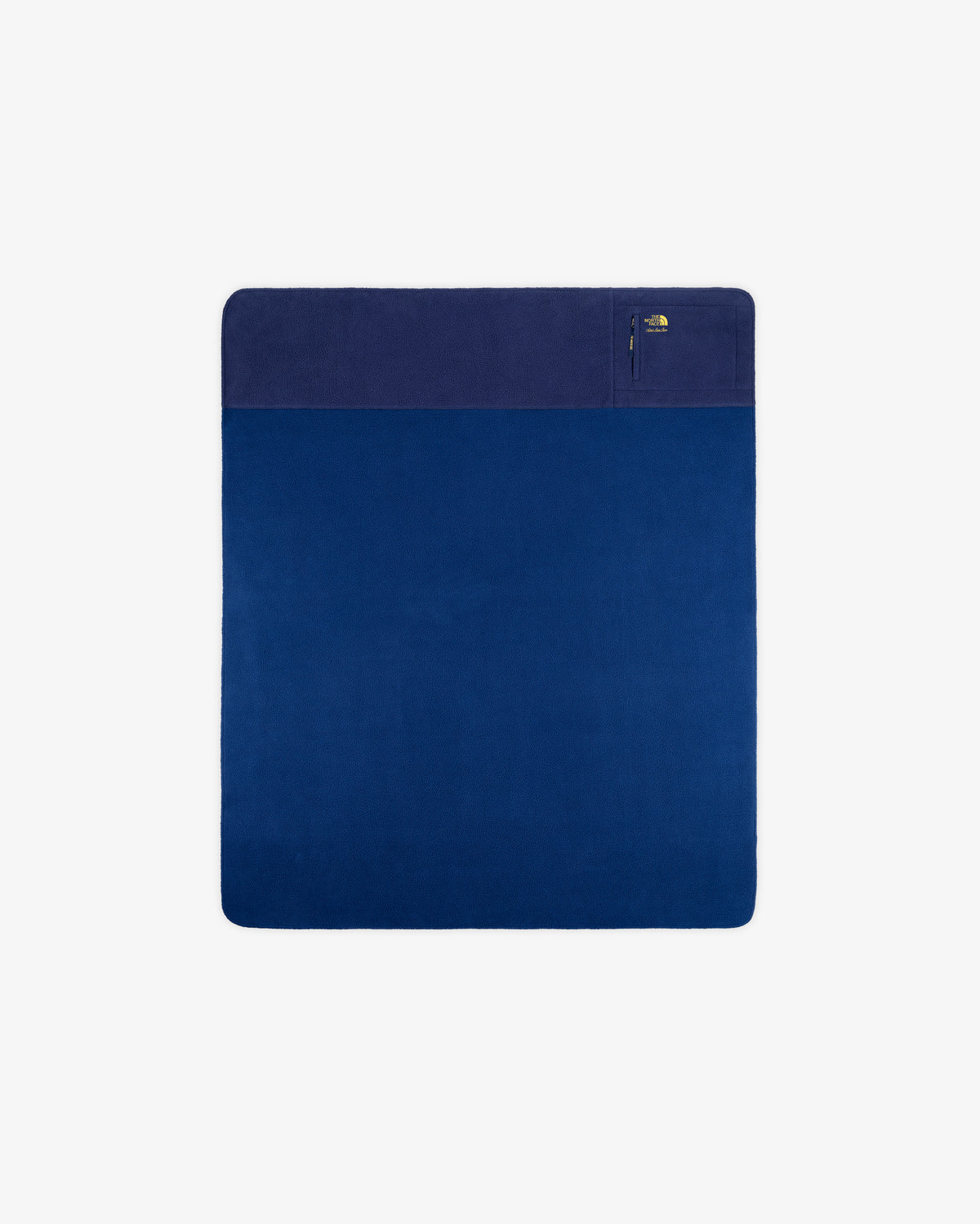 ALD/The North Face dark blue packable fleece blanket with a pale blue edge and a zippered corner pocket.