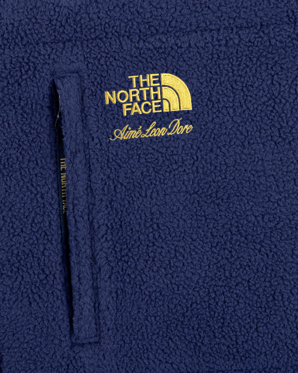 Close-up of the ALD / The North Face Packable Fleece Blanket with co-branded yellow embroidered logos.