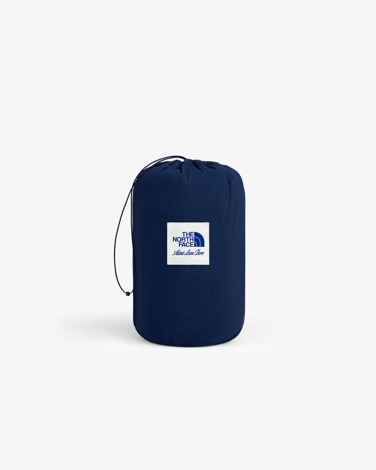 A navy ALD/The North Face packable fleece blanket with white logo patch, drawstring, and simple background.