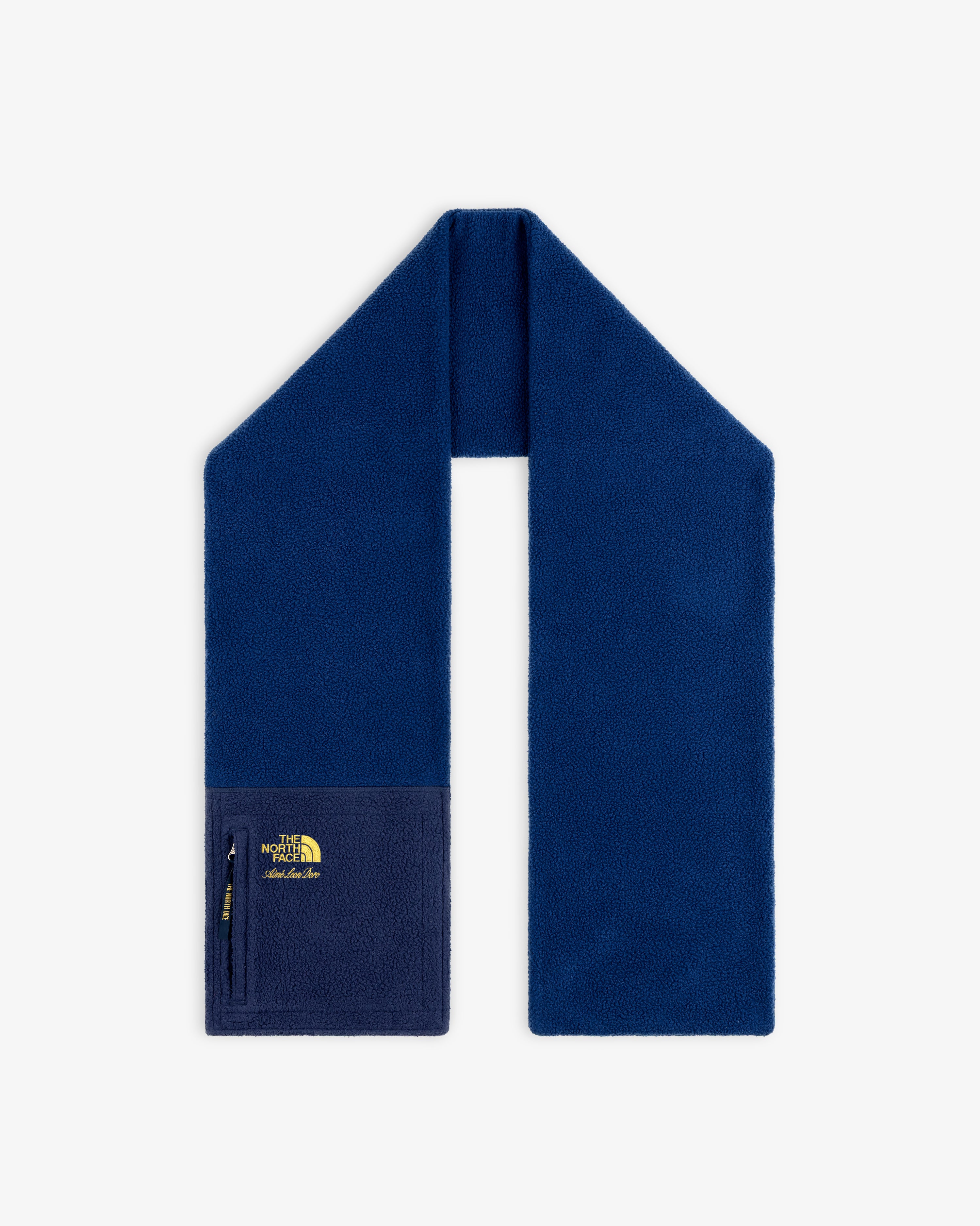 ALD / The North Face Denali Fleece Scarf in dark blue with a zip pocket and yellow logo, shown on white background.