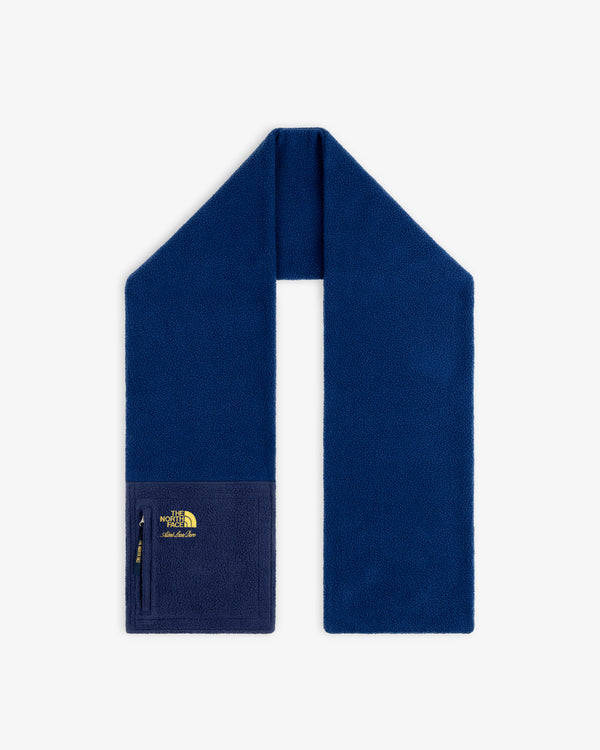 ALD / The North Face Denali Fleece Scarf in dark blue with a zip pocket and yellow logo, shown on white background.