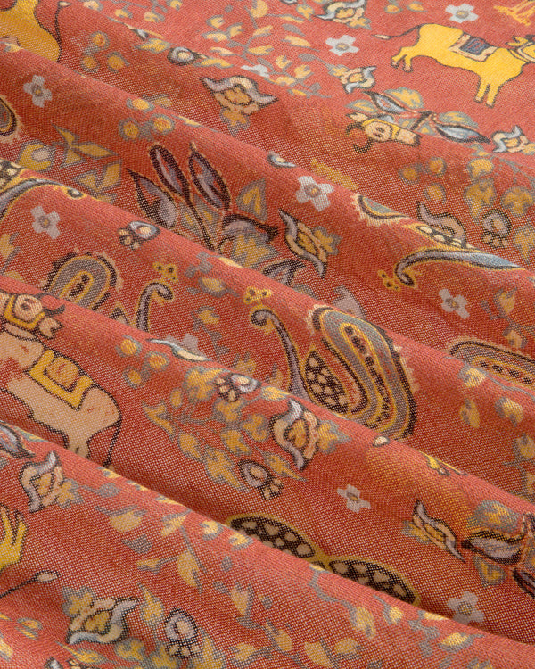 Archival Print Wool Silk Bandana in rust, with paisley, floral, elephant & deer motifs; shown softly folded.