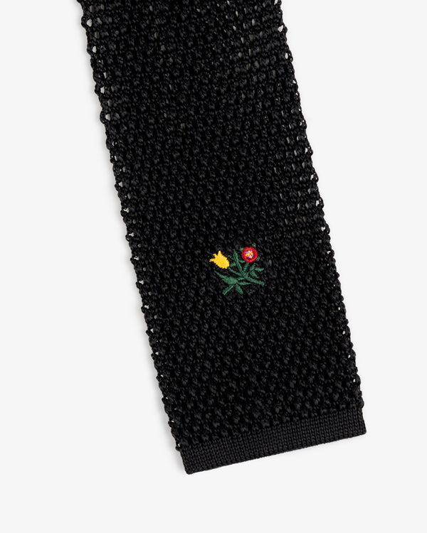 Crest Silk Knit Tie in black, featuring a small embroidered flower bouquet.