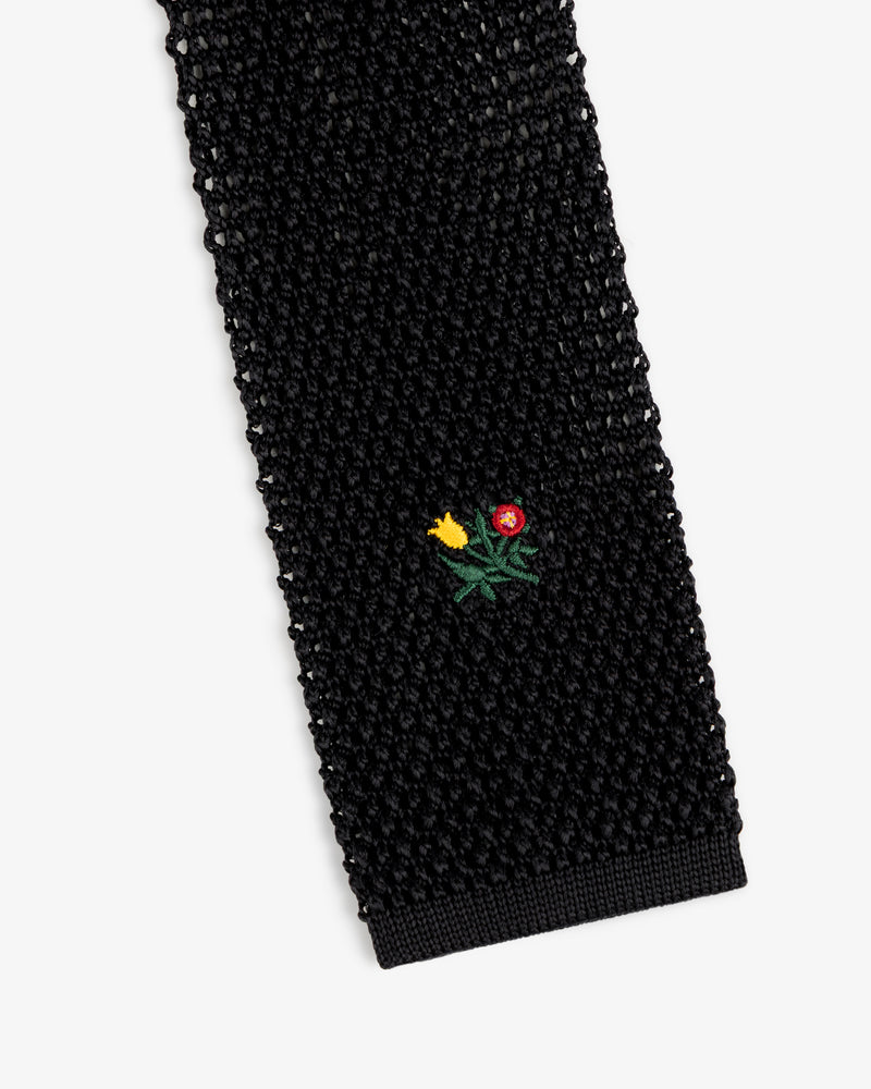 Crest Silk Knit Tie in black, featuring a small embroidered flower bouquet.
