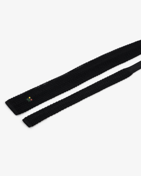 Crest Silk Knit Tie in black with small floral embroidery near the tip.