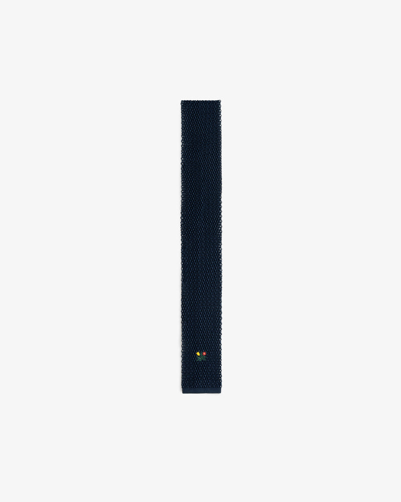 Dark navy Crest Silk Knit Tie with a small floral embroidery near the pointed tip.