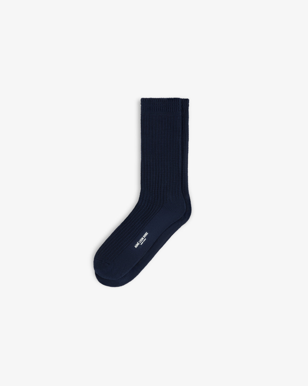 A pair of navy blue Cotton Waffle Sock crew socks with white branding on the side.