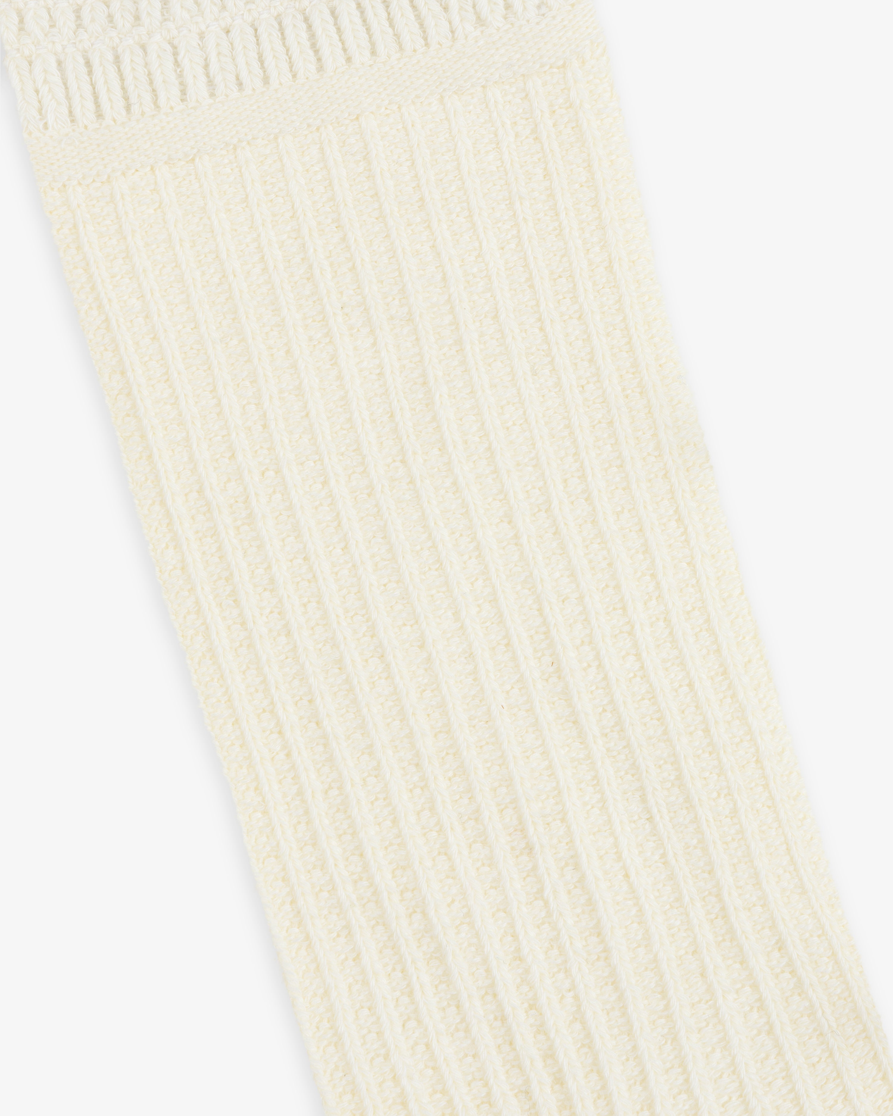 Off-white Cotton Waffle Sock with a ribbed, textured cuff.