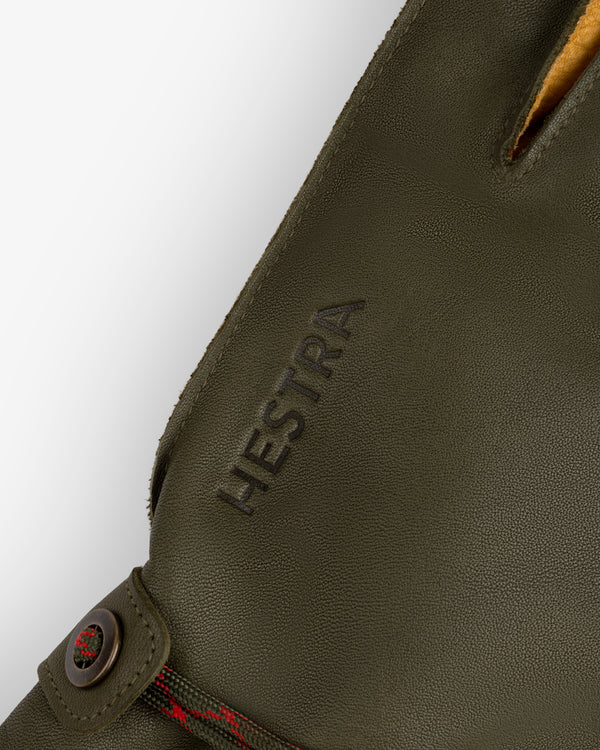 Olive green leather Wakayama Gloves with a snap closure and the brand name embossed on the wrist.