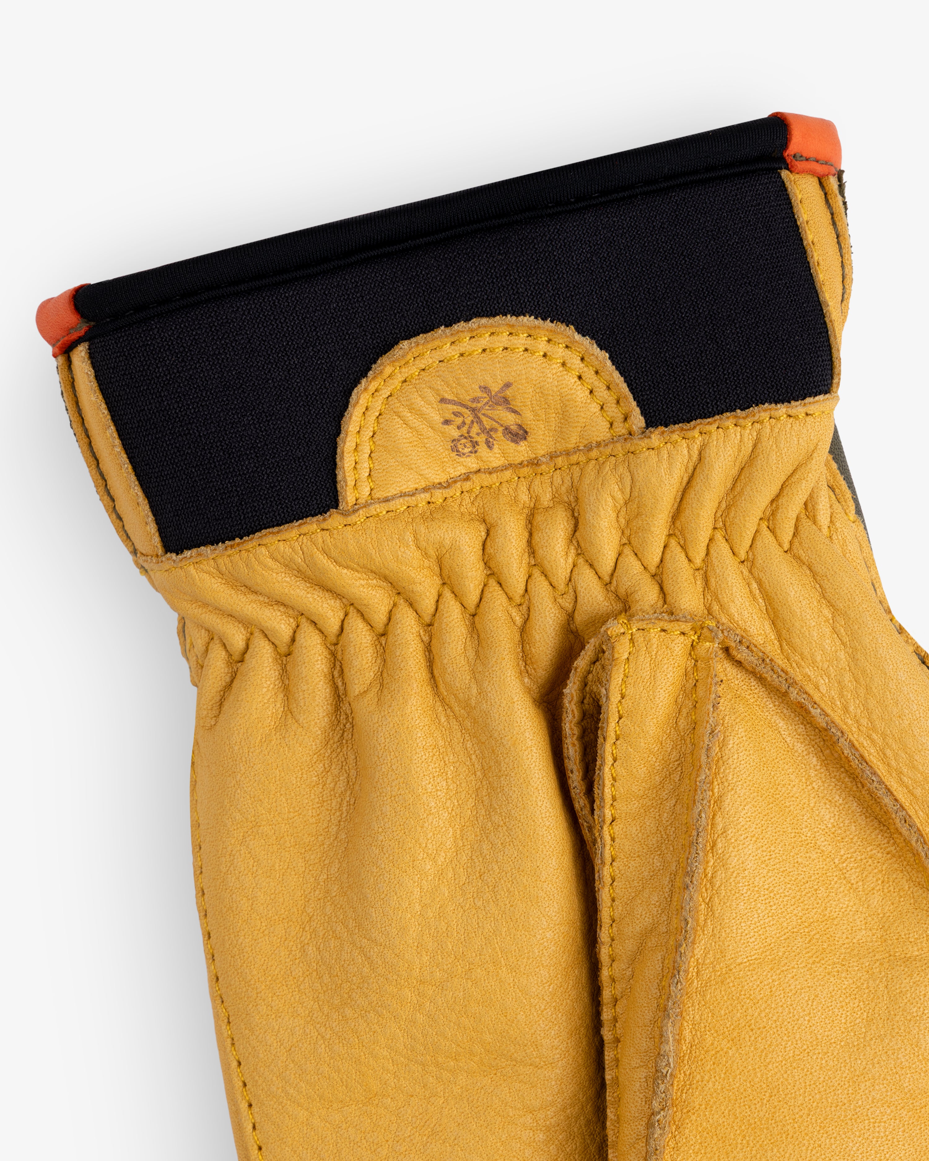 Wakayama Gloves in tan leather with a black elastic cuff and orange trim.