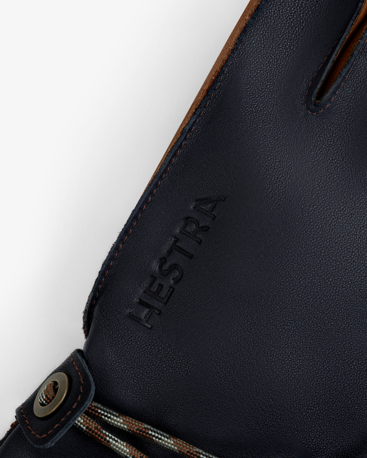Dark blue leather Wakayama Gloves with an embossed brand name and a small drawstring detail at the wrist.