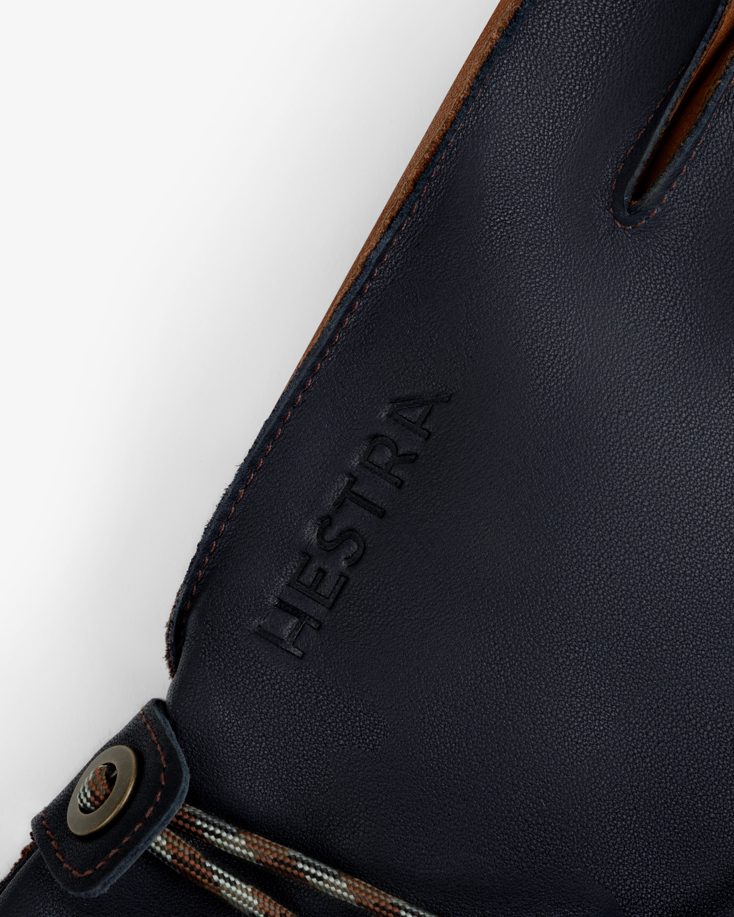 Dark blue leather Wakayama Gloves with an embossed brand name and a small drawstring detail at the wrist.