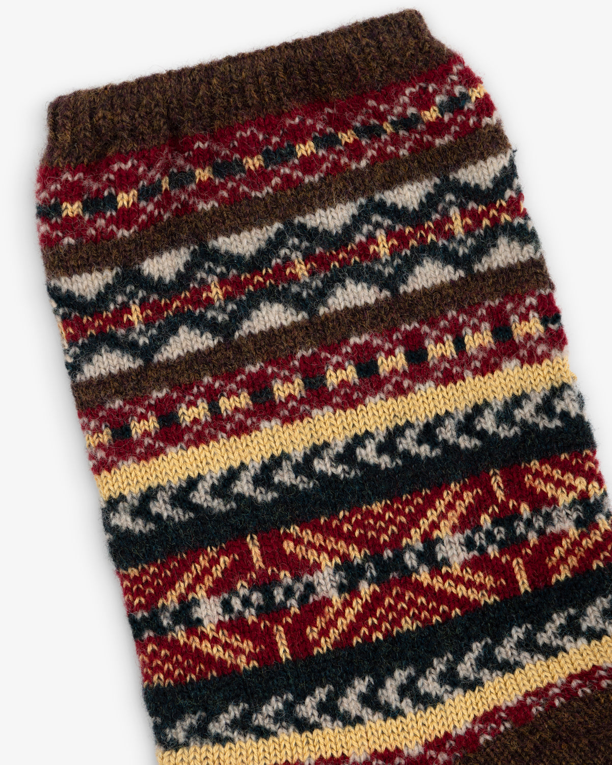 Fair Isle Quarter Sock in a multicolored Fair Isle knit pattern of brown, red, yellow, and cream.