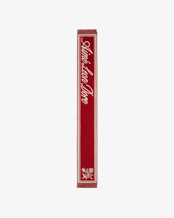 Red Wool Script Scarf featuring white script text and a floral graphic at the bottom.